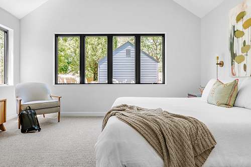 indoors whtie bed comforter interior design